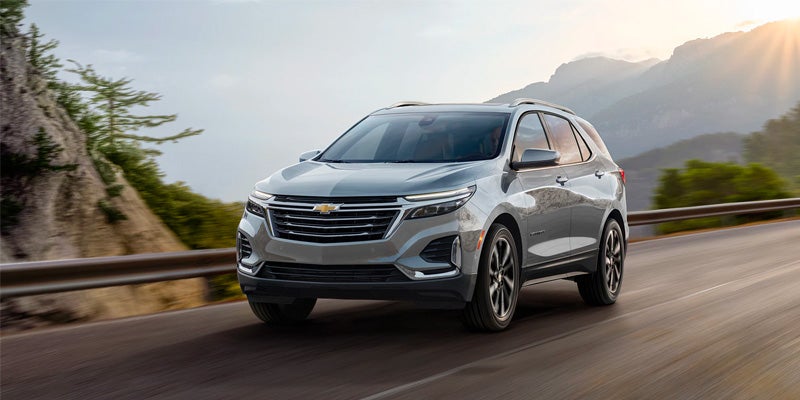 Silver Chevrolet Equinox running on flyover