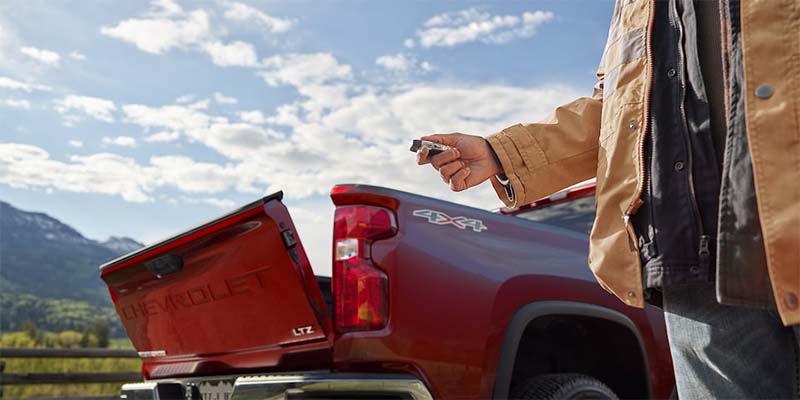 Man opening Chevy Silverado-2500 HD tailgate remotely