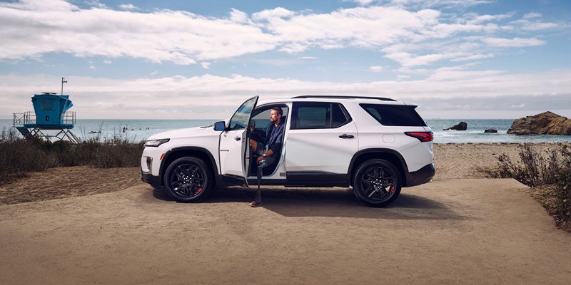 White Chevy Traverse parked at near lake